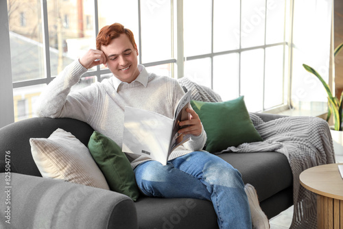 Young man reading magazine ...