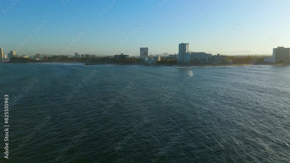 Aerial video of Mazatlán at dawn from Isla de los Venados, highlighting the vast ocean, morning currents, and numerous birds flying along the rocky island's picturesque coastline Aerial video of Mazatlán at dawn from Isla de los Venados, highlighting the vast ocean, morning currents, and numerous birds flying along the rocky island's picturesque coastline