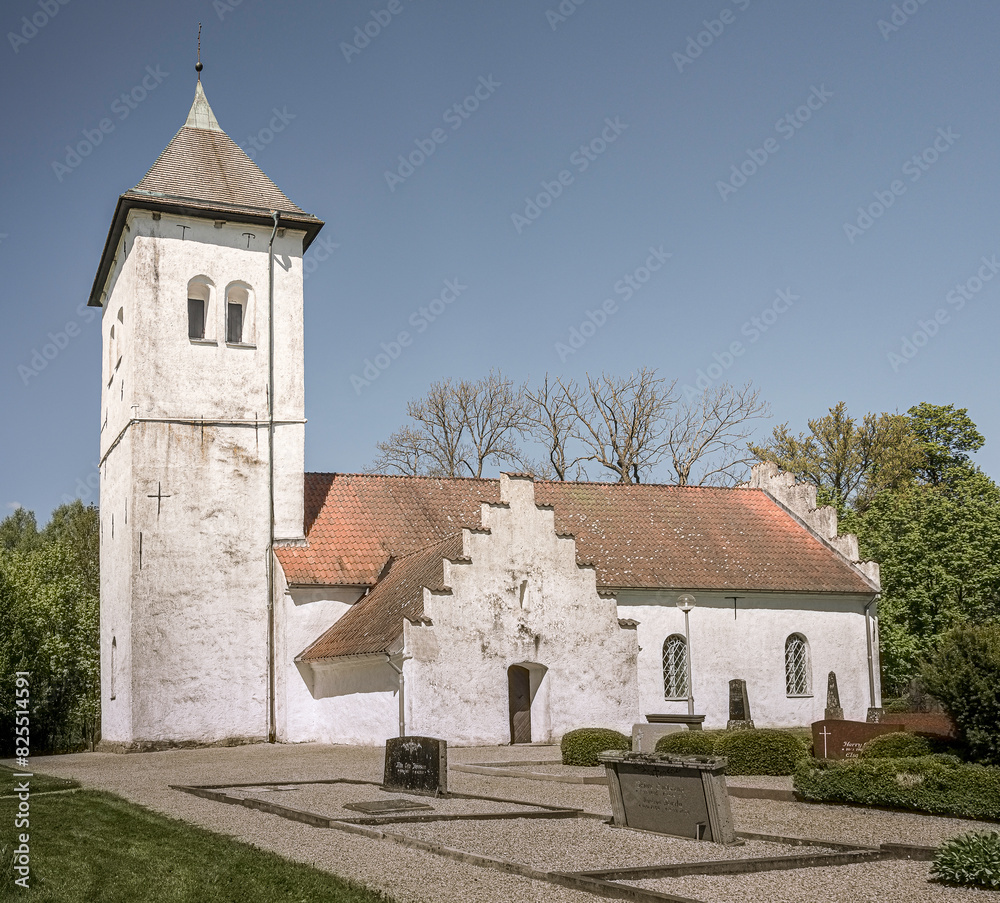 whitewashed Scandinavian church with towers reaching for the blue sky