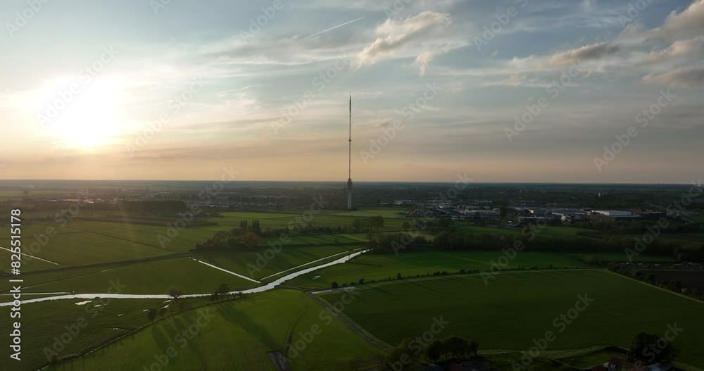 Birds eye view on the Gerbrandytoren, Zendmast Lopik, concrete tower with a transmission mast in the Dutch IJsselstein at sunset. Birds eye view on the Gerbrandytoren, Zendmast Lopik, concrete tower with a transmission mast in the Dutch IJsselstein at sunset.