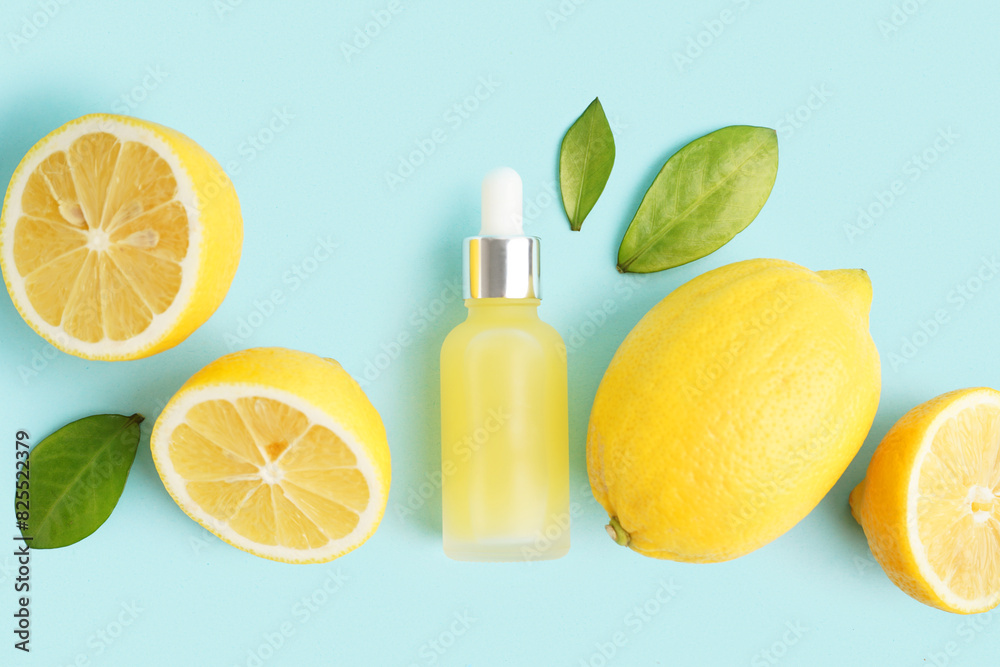 Bottle of essential oil and fresh lemons on color background Bottle of essential oil and fresh lemons on color background