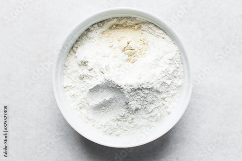 All purpose flour and vital wheat gluten in a ceramic bowl, process of making bread flour