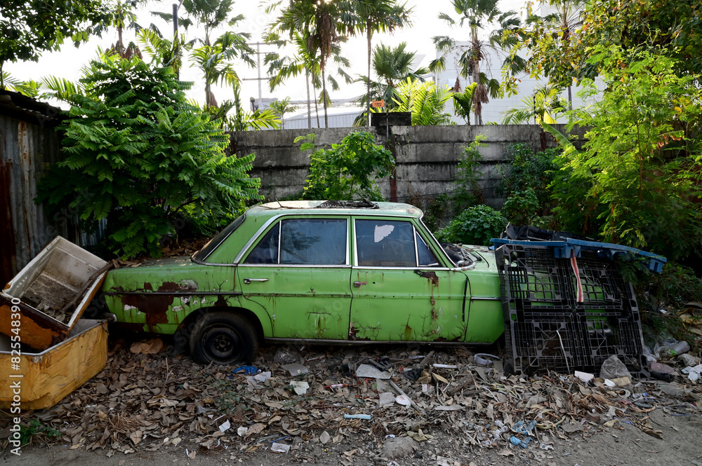 BANGKOK, THAILAND - May 23, 2024: Old car parked for a long time beside the road in Thailand. BANGKOK, THAILAND - May 23, 2024: Old car parked for a long time beside the road in Thailand.