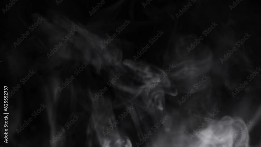 puffs of white smoke on a dark background
