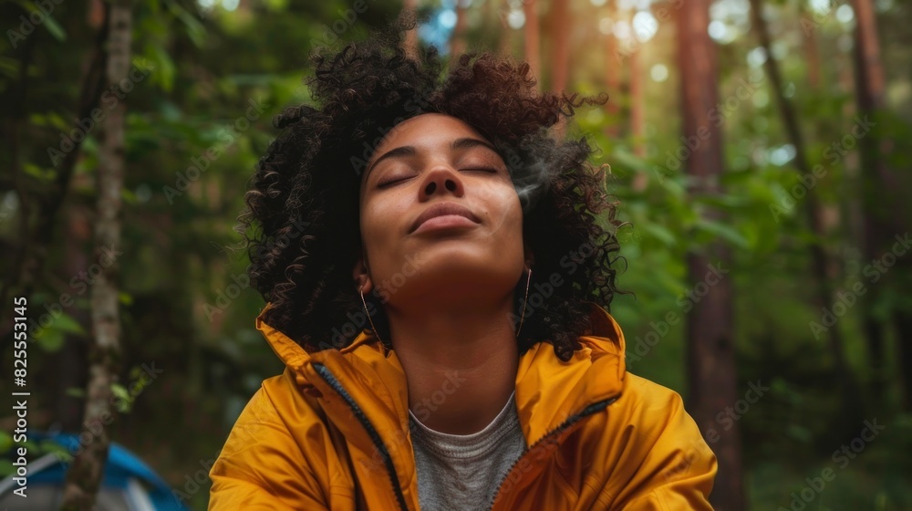 beautiful brunette woman with closed eyes enjoying nature in the middle of the forest during the day beautiful brunette woman with closed eyes enjoying nature in the middle of the forest during the day