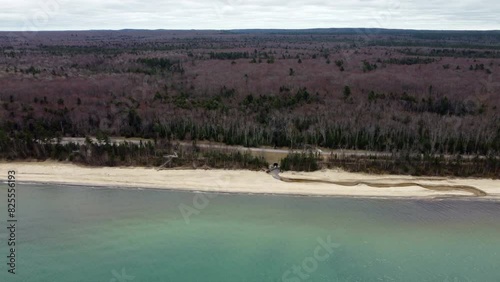 Drone shot flying from over water to land Burt Lake Superior Michigan photo