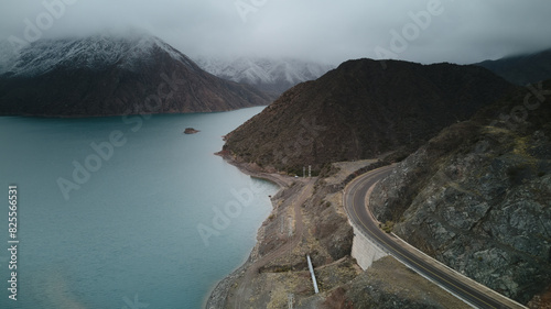 Snowy mountains and road by Lake Potrerillos in Mendoza, Argentina. Aerial view, high angle.