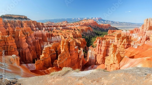 Stunning Panorama of Bryce Canyon National Park Featuring Vibrant Red Rock Hoodoos and Snow-Capped Mountains Under Clear Blue Skies