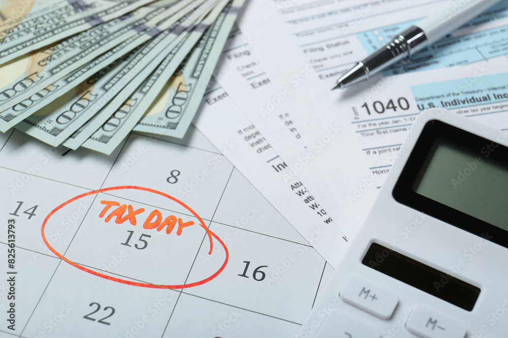 Calendar with date reminder about tax day, documents, pen, calculator and money, closeup Calendar with date reminder about tax day, documents, pen, calculator and money, closeup