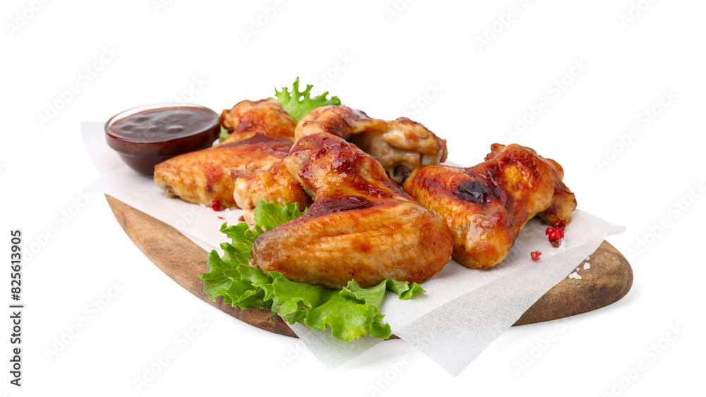 Board with marinade, chicken wings, spices and lettuce isolated on white
