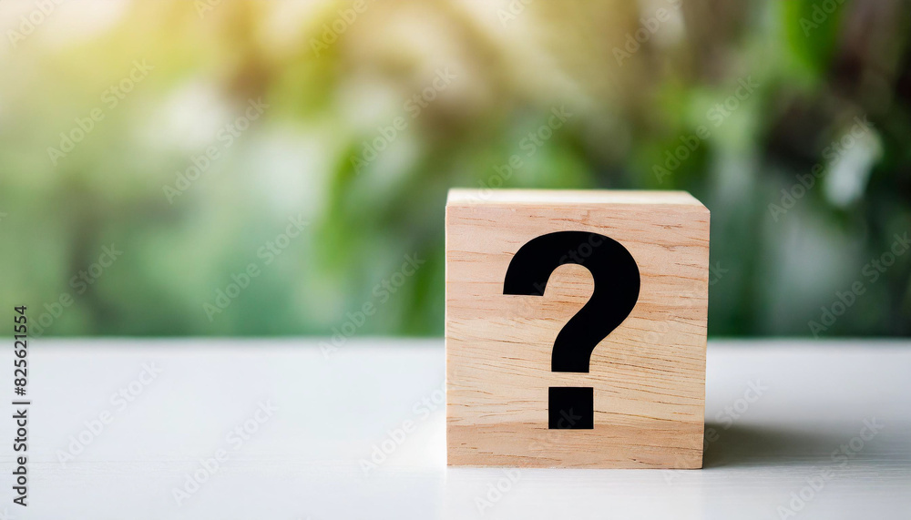 wooden block with a question mark stands on a white table, symbolizing uncertainty or inquiry. The minimalist backdrop emphasizes the concept, providing ample caption space on the right wooden block with a question mark stands on a white table, symbolizing uncertainty or inquiry. The minimalist backdrop emphasizes the concept, providing ample caption space on the right