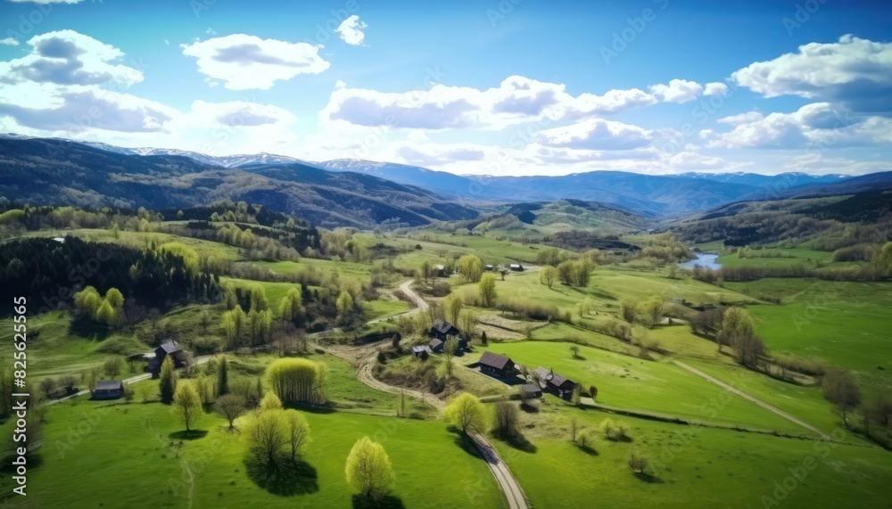 Views of fertile land surrounded by stunning green vegetation, rolling hills and mountains with clear skies in spring.