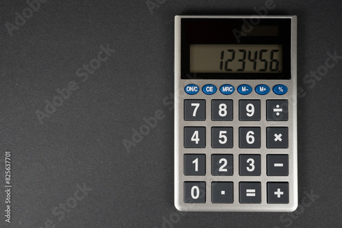 A Calculator Isolated On A Black Desk With Room For Copy On The Left © John