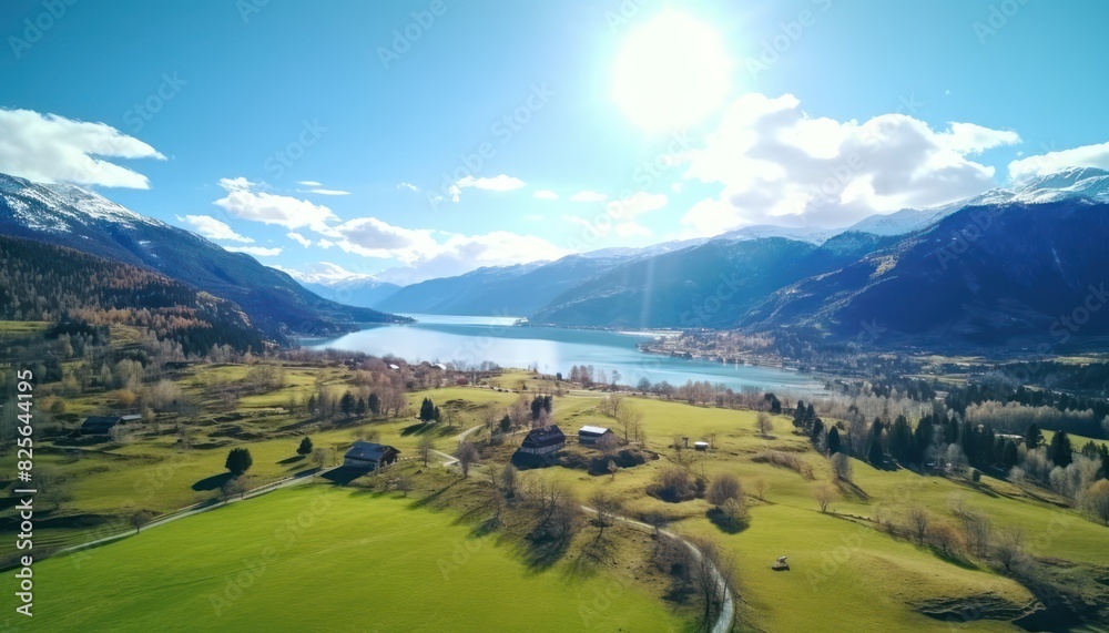 Obraz premium Stunning spring views of the countryside and green grass and beautiful flowers, with rolling hills and fertile soil, against a backdrop of vast mountains