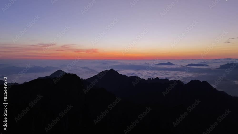The morning sun rises from the high mountain clouds and mist,Mount Huangshan, China The morning sun rises from the high mountain clouds and mist,Mount Huangshan, China