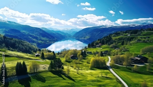 Stunning spring views of the countryside and green grass and beautiful flowers  with rolling hills and fertile soil  against a backdrop of vast mountains