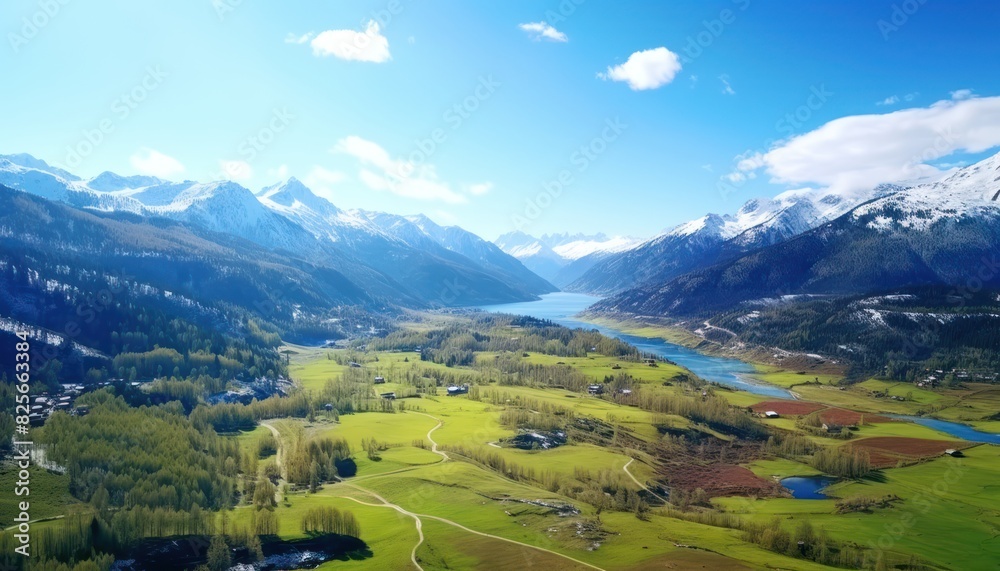 Fototapeta premium Stunning spring views of the countryside and green grass and beautiful flowers, with rolling hills and fertile soil, against a backdrop of vast mountains