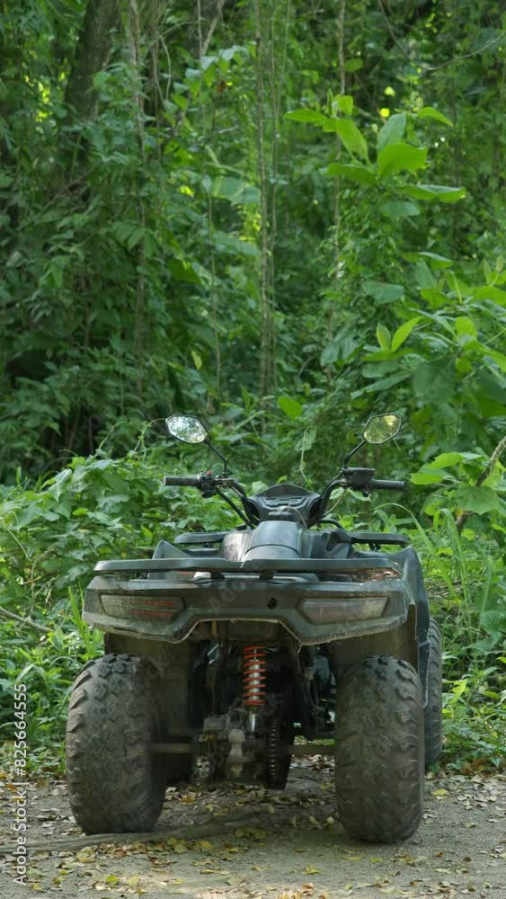 ATV parked in the forest on a sunny summer day. ATV parked in the forest on a sunny summer day.