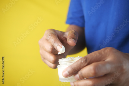 Close up of man hand using petroleum jelly photo