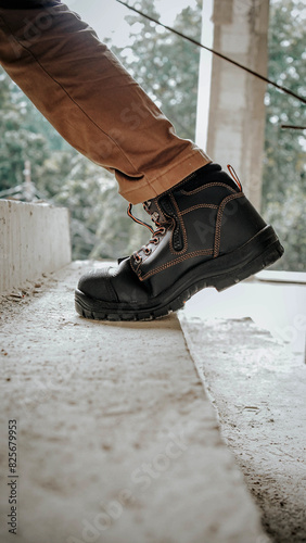 A construction worker wears brown leather boots which looks very cool and fashionable
