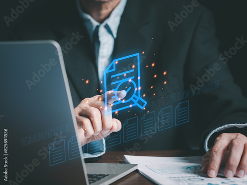 Businessmen working on laptop shows the virtual screen with icon document data to transfer, backup, and download documents online. Receive - send, and exchange databases, (DMS). Business concept.