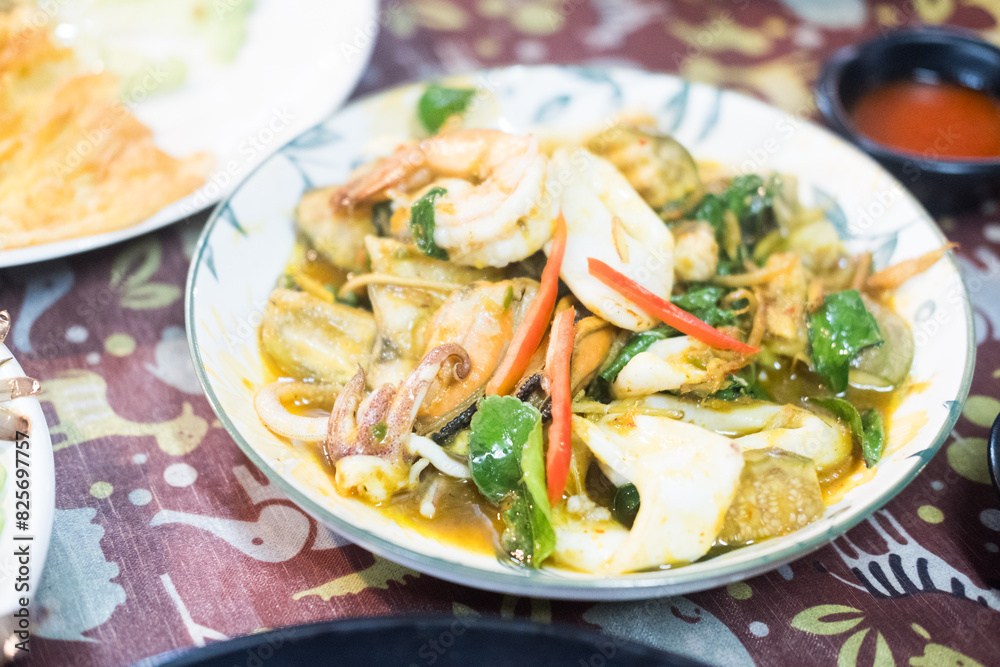 Squid, shrimp and fish stir fried with Thai kaffir lime and peppers. Thai seafood Squid, shrimp and fish stir fried with Thai kaffir lime and peppers. Thai seafood
