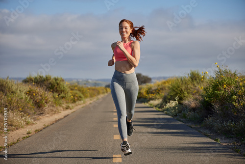 Redhead woman running outdoors.
