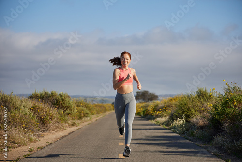 Redhead woman running outdoors.