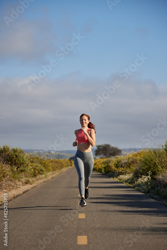 Redhead woman running outdoors.
