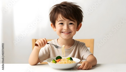 A cheerful child with a different hairstyle, smiling and enjoying a plate of pasta with vegetables. The child is sitting at a table.