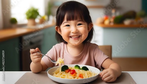 A cheerful Asian child with a different hairstyle  smiling and enjoying a plate of pasta