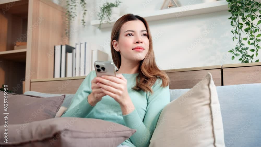 A woman using chat message app on smartphone, in response to communication. A woman using chat message app on smartphone, in response to communication.