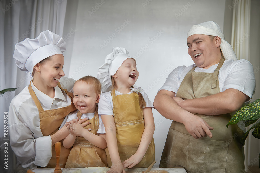 Cute oriental family with mother, father, daughter, son cooking in kitchen on Ramadan, Kurban-Bairam, Eid al-Adha. Funny family at photo shoot. Easter Cute oriental family with mother, father, daughter, son cooking in kitchen on Ramadan, Kurban-Bairam, Eid al-Adha. Funny family at photo shoot. Easter
