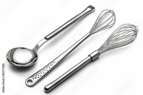 Image shows a stainless steel spoon  whisk  and spatula.