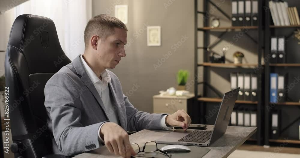 Tired worker look at computer laptop screen read email sitting at workplace. Frustrated entrepreneur overworked at desktop Tired worker look at computer laptop screen read email sitting at workplace. Frustrated entrepreneur overworked at desktop