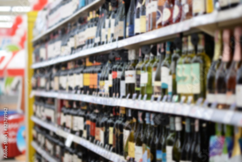 A woman shopping with a cart in a supermarket aisle full of groceries blur lens camera