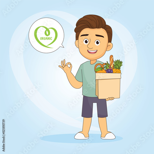 Young man standing and holding basket with fresh raw organic vegetables and fruits in hands
