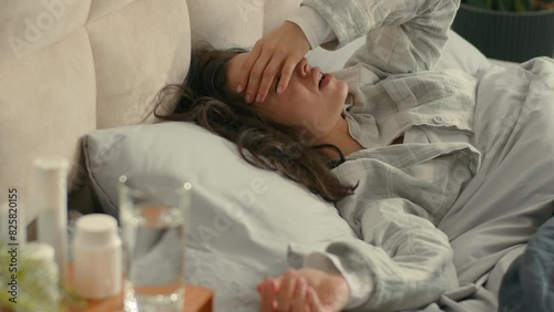 Sick woman lying on bed bedroom home headache illness cough unhealthy epidemic female fever flu girl disease medicine temperature symptom unwell virus unhappy cold tired patient pill drug treatment