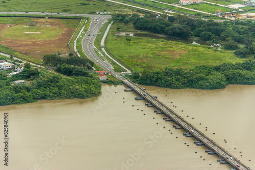 The world's longest movable vehicular pontoon bridge over the Demerara River in Georgetown, Guyana, South America. Aerial view. World tourism, attractions, landscape.