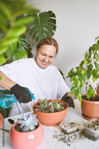 In a cozy room, a smiling woman tends to her beloved plants with care, creating a green oasis in her home. Her happy demeanor reflects her love for gardening, making balcony a cheerful haven