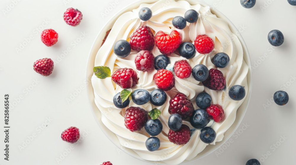 A top view of a fruit cake with berries, coated in whipped cream at the center, set against a light background A top view of a fruit cake with berries, coated in whipped cream at the center, set against a light background