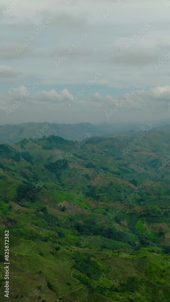 View of the valley in the mountain province. Jungle hills in the highlands of Philippines. Mindanao. Vertical view. View of the valley in the mountain province. Jungle hills in the highlands of Philippines. Mindanao. Vertical view.