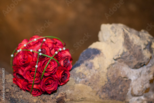 Elegant red roses, white pearls on rustic rock for weddings, events, or gifts with a romantic touch photo