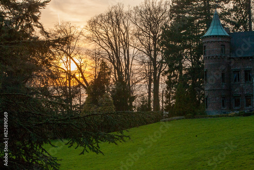 The tranquil atmosphere of a forested brick castle at sunset is stunning, evoking a sense of peace and serenity