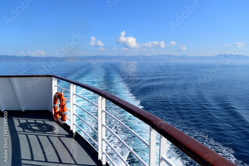 the ship leave away the shore on a gorgeous summer morning - an aft corner of the deck, the rail, the ship's wake (backwater, swirl), a lot of blue