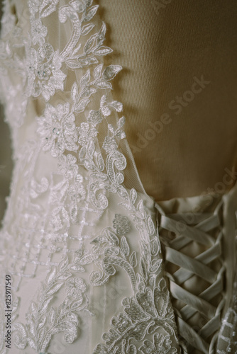 Close-up of a beautiful white gown, showcasing intricate details and delicate craftsmanship.