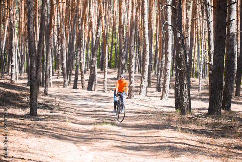 woman cyclist rides in the forest on a bike.