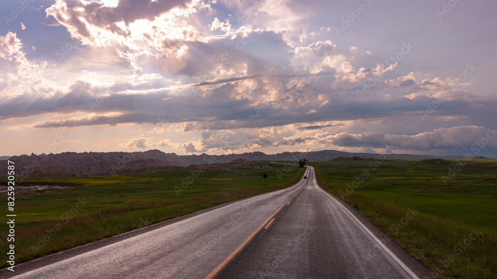 A lonely road on the prairie toward Badlands National Park after a summer storm, South Dakota