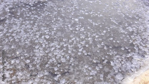 Close-up of the natural salt formations in a salt lake, showcasing crystalized patterns of edible salt. A fine display of natural mineral textures.