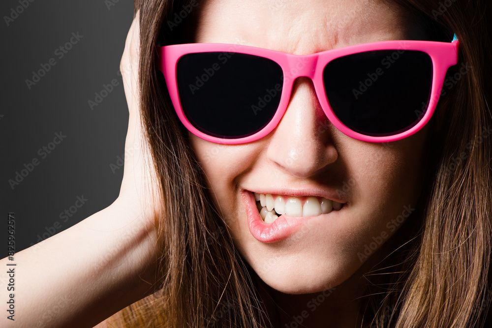 Black background, funny face and girl with sunglasses, studio and style of Gen z, fashion and accessory. Confidence, crazy and person with eyewear, color and trendy in weekend, shades and portrait